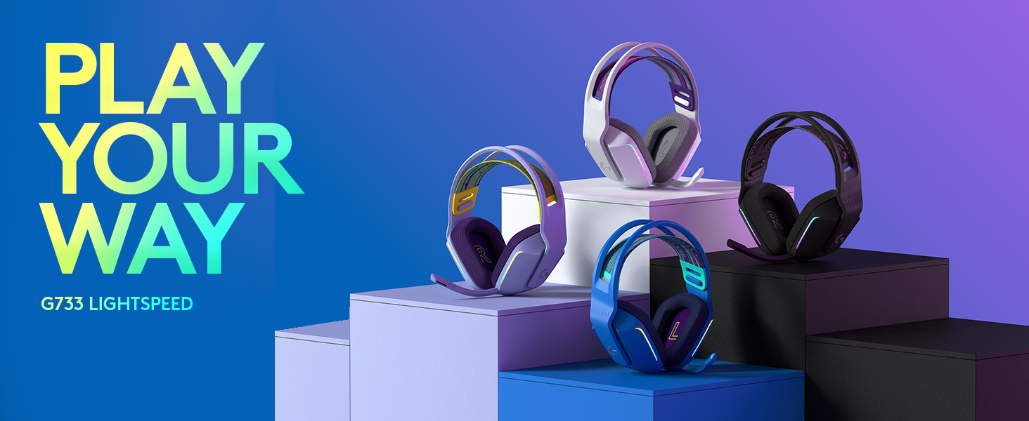 Logitech G733 LIGHTSPEED wireless gaming headsets in multiple colors on display pedestals with 'Play Your Way' slogan.